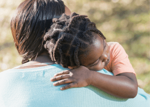 Parent comforts anxious child before an oral food challenge. Normalizing food allergy anxiety in children. You can get food allergy parenting therapy and teletherapy in Westfield, NJ and Cranford, NJ with Brave Minds in Scotch Plains, NJ