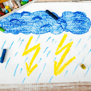 Child's drawing of a blue cloud and yellow lightning bolts using crayons. Providing a safe environment for a child to face their fear of thunderstorms can be helpful in reducing child anxiety toward weather. Find a child therapist near you to help!