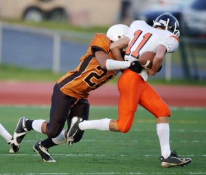 A student-athlete football player tackles someone on the other team. Learn more about support for student-athletes by searching for teen counselor Scotch Plains, NJ and other services. Search for therapy for teens in Branchburg, NJ to learn more.