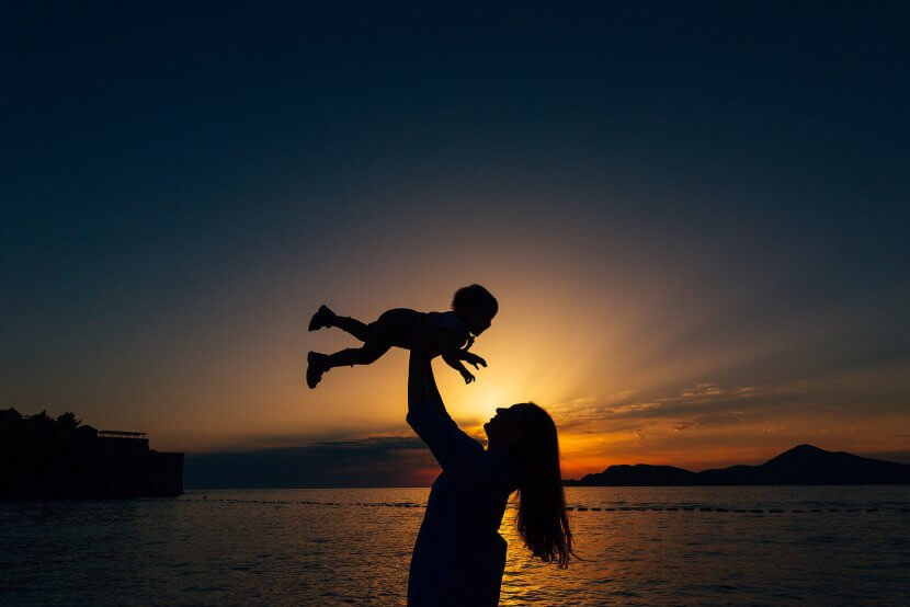 A silhouette of a mother holding their child above their head against the sunset. Learn how a child therapist in Branchburg, NJ can offer support by searching for child therapy in New Jersey. Child counseling in Branchburg, NJ can offer support today.