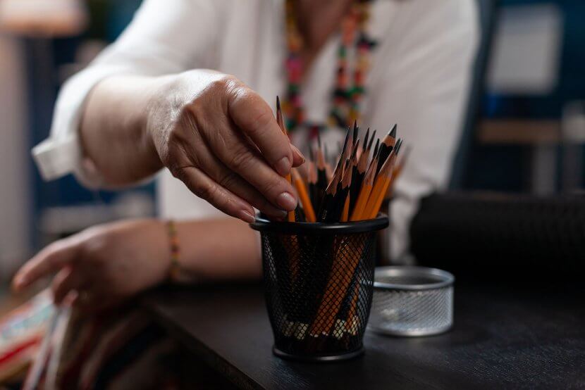 A close up of a teacher picking out a pencil from their holder. This could represent the stress of starting a new school year that anxiety treatment in Branchburg, NJ can help you and your child overcome. Learn more about the support an anxiety therapist in Branchburg, NJ can offer by searching for "anxiety in teens branchburg, nj" today.