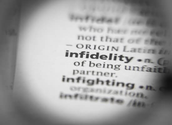 A close up of a definition for infidelity in a book. Learn how a couples counselor in Branchburg, NJ can offer support with counseling in Branchburg, NJ and other services to address infidelity. Search for "couples therapy branchburg, NJ" for more support today.