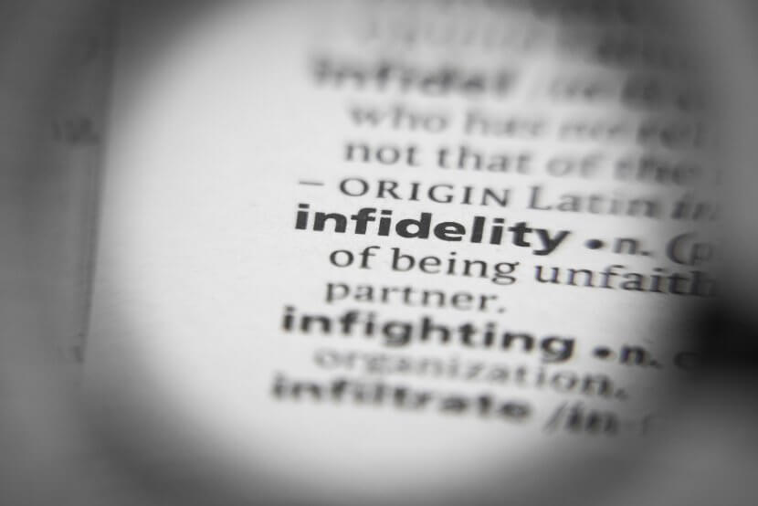 A close up of a definition for infidelity in a book. Learn how a couples counselor in Branchburg, NJ can offer support with counseling in Branchburg, NJ and other services to address infidelity. Search for "couples therapy branchburg, NJ" for more support today.